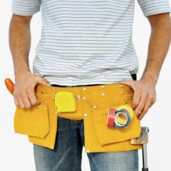 Mid section of a workman wearing a tool belt